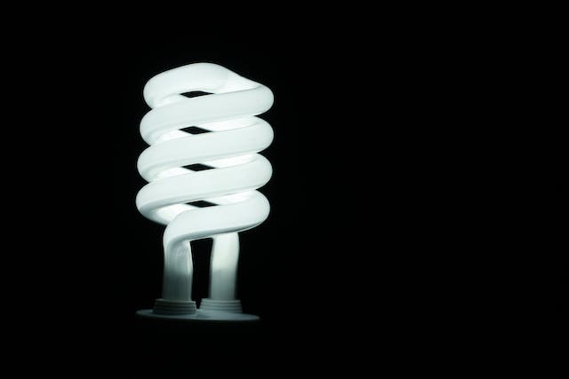Compact fluorescent lamp against a dark background