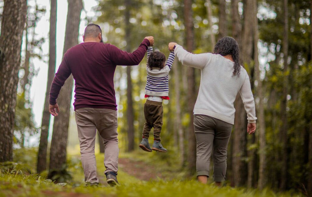 Parents with walking in a park with a kid