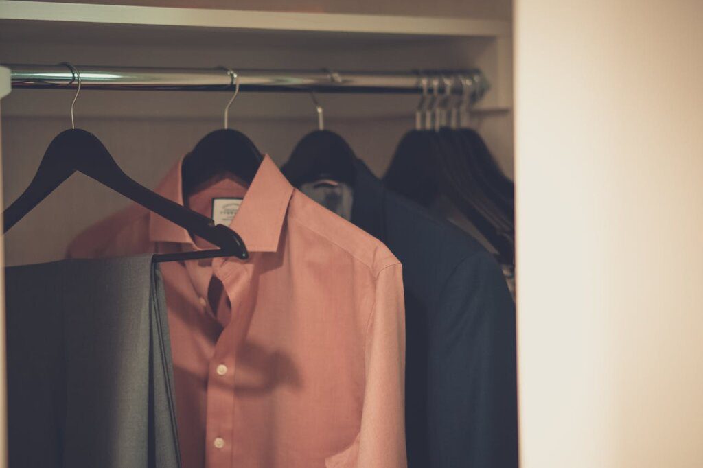 Shirts on hangers inside the closet