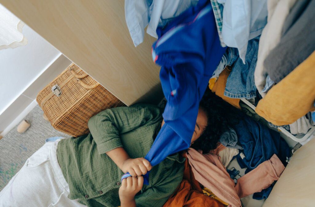 A person under a pile of clothes.