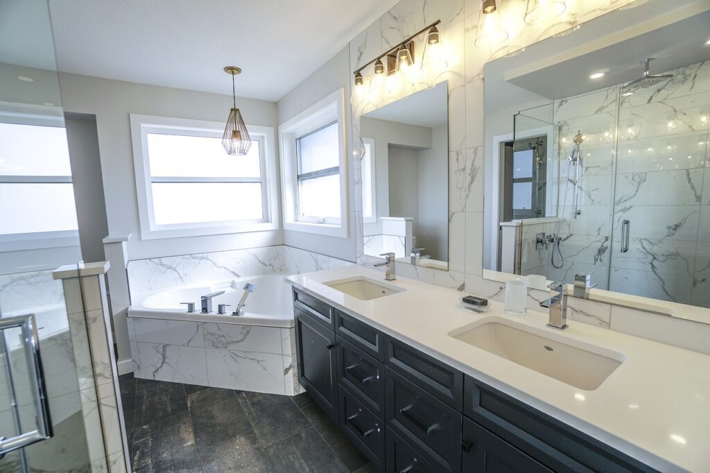 Modern bathroom with dual sinks, marble accents, and a spacious shower.