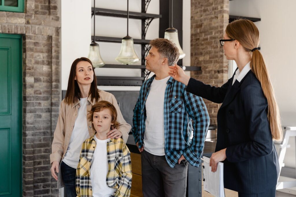 Real estate agent showing the house interior to a family.