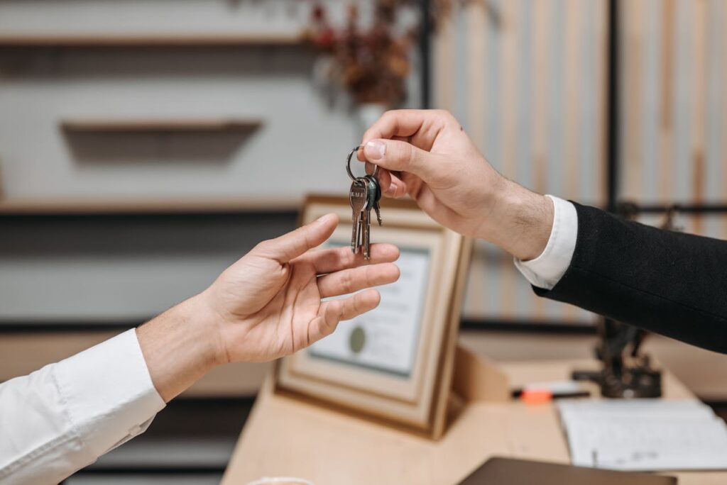 One person handing keys to another.