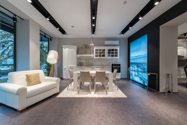 A spacious modern living room and dining area with contemporary furniture and bright light